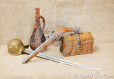 Bottle, rapier, sword, pistol and chest Stock Photo