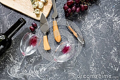 Bottle of red wine with cheese and grape aperitive on grey stone table background copyspace top view Stock Photo