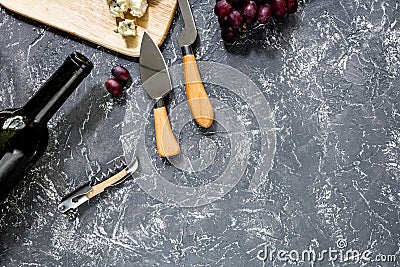 Bottle of red wine with cheese and grape aperitive on grey stone table background copyspace top view Stock Photo