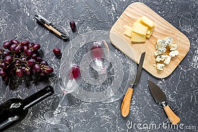 Bottle of red wine with cheese and grape aperitive on grey stone table background top view Stock Photo