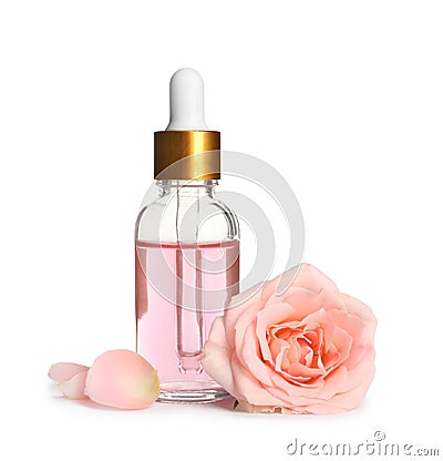 Bottle of rose essential oil and flower on white Stock Photo