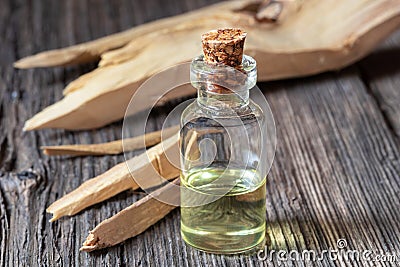 A bottle of sandalwood essential oil with white sandalwood Stock Photo