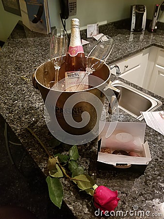 A bottle of sparkling cider on ice and a box of romantic chocolate Editorial Stock Photo