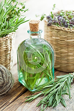 Bottle of essential rosemary oil or infusion Stock Photo