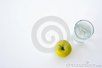 Bottle of water, green apple, glass of water and measuring tape isolated on white. Stock Photo