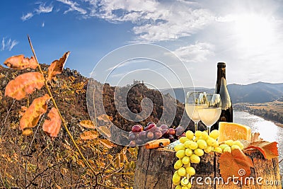 Bottle of wine on barrel against Duernstein castle close to Danube river during autumn in Wachau, Austria Stock Photo