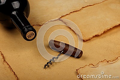Bottle of wine with cork and opener on brown paper Stock Photo