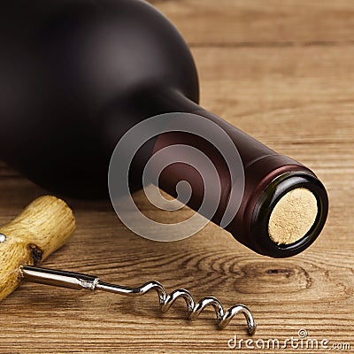 Bottle of Wine and Corkscrew on Wood Stock Photo