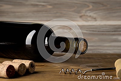 Bottle of wine with corkscrew on wooden background Stock Photo