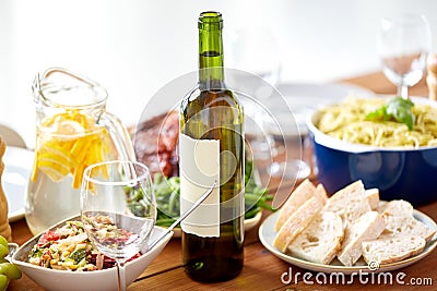 Bottle of wine and food on served wooden table Stock Photo