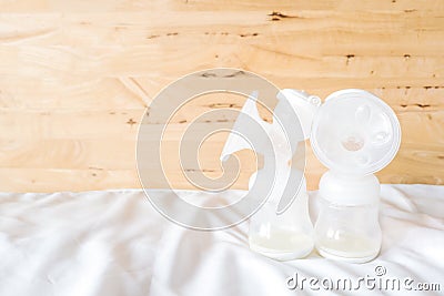 Bottles of automatic breast pump with fresh mother breast milk f Stock Photo