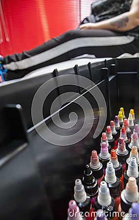 Bottles of colourful tattoo ink, in a tattoo parlor with costume Stock Photo