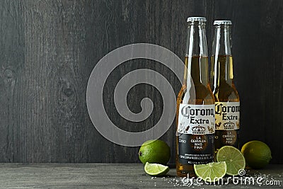 Bottles of Corona Extra and limes against dark wooden background Editorial Stock Photo