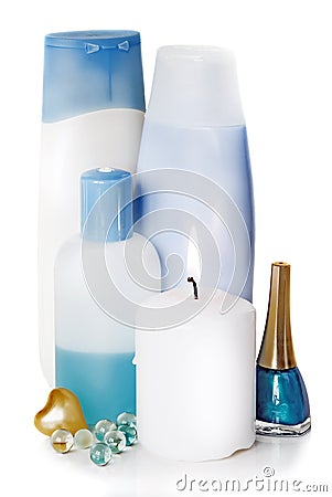 Bottles with different cosmetics and a burning candle Stock Photo