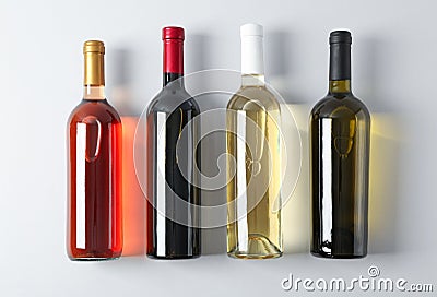 Bottles with different wine on grey background Stock Photo