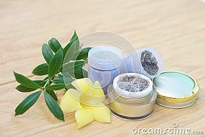 Bottles of homemade Thai herbal powder for smell to relieve dizzy symptoms, decorate with yellow flower Stock Photo