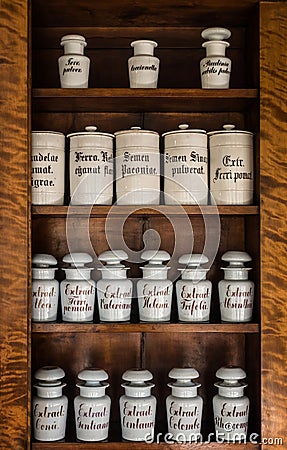 Bottles with medicines on the shelf in old pharmacy. Old pharmacy, medicine and chemistry background. Stock Photo