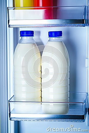 Bottles of milk in the fridge Stock Photo