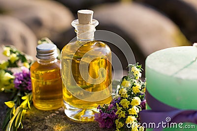 Bottles with natural aroma oil over nature background. Stock Photo