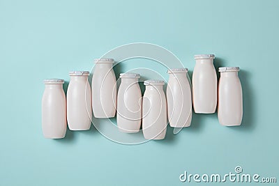 Bottles with probiotics and prebiotics dairy drink on light blue background. Stock Photo