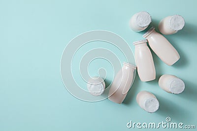 Bottles with probiotics and prebiotics dairy drink on light blue background. Stock Photo