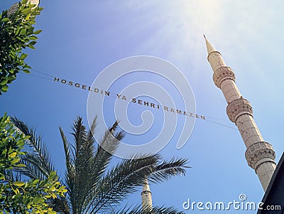 bottom-up view of the inscription of Hosgeldin ya sehri Ramazan between the minarets. Translation from turkish: Welcoming Ramadan Stock Photo