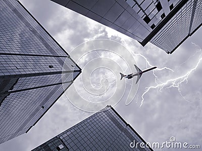 Bottom view of airplane flying above skyscraper Stock Photo