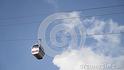 Bottom view of the funicular cable railway, cabins moving on blue cloudy sky background. Action. New cabins moving Editorial Stock Photo