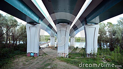 Bottom view of a huge flyover motorway, blue sky, large pillars with sunlight. Editorial Stock Photo