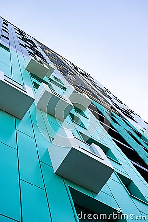 bottom view of a multi-storey modern aqua colored building . urban jungle Stock Photo