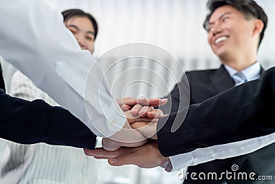 Bottom view partial hand join stack as symbol of harmony in office Stock Photo