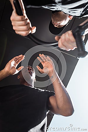 Bottom view of policeman holding truncheon Stock Photo