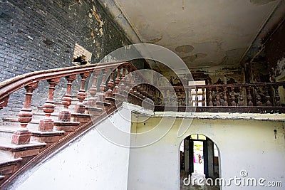 Bottom view of a wooden staircase in an old castle in light colors Stock Photo