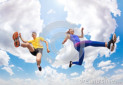 Athletes remains in air while jumping against sky Stock Photo