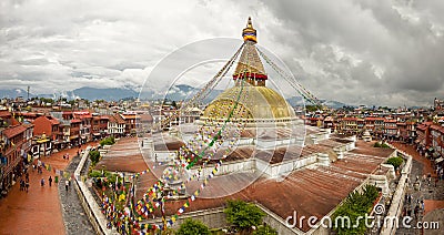 Boudhanath Stupa and Adjacent Buildings in Kathmandu of Nepal against Cloudy Sky from above Stock Photo