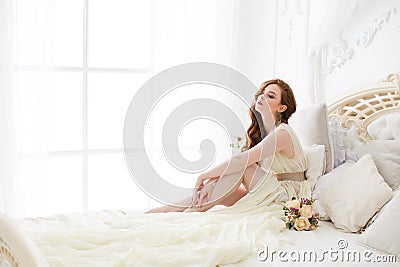 Boudoir Bride`s morning. Cute red-haired girl in her wedding day Stock Photo