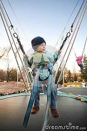 Bouncing in bungee trampoline Stock Photo