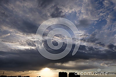 the boundless expanse of the sky with cumulus clouds and rays of the sun, moments of daybreak and sunset Stock Photo