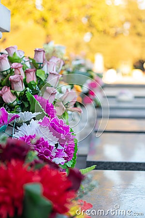 Bouqets of flowers laying on gravestones Stock Photo