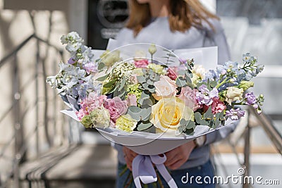 Bouquet of beautiful flowers in women`s hands. Floristry concept. Spring colors. the work of the florist at a flower Stock Photo