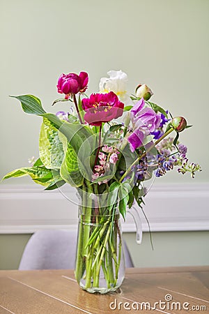 Bouquet of bright flowers on the table in jug Stock Photo