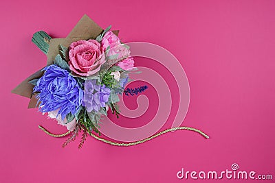 A bouquet of colorful paper flowers on a magenta background as a backdrop for a postcard, invitation letter and etc Stock Photo