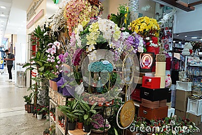 Bouquet of colorful roses and other different flowers at the entry to flower shop at farmers` market. Colorful peony, roses etc. Editorial Stock Photo