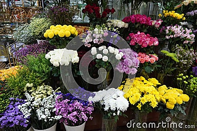 Bouquet of colorful roses and other different flowers at the entry to flower shop at farmers` market. Colorful peony, roses etc. Stock Photo