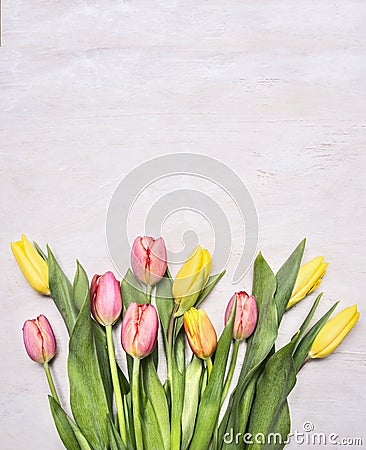Bouquet of colorful spring tulips on wooden rustic background top view close border ,place for text Stock Photo