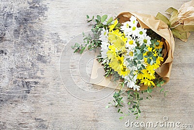 Bouquet daisy chamomile flowers on wooden garden table. Stock Photo