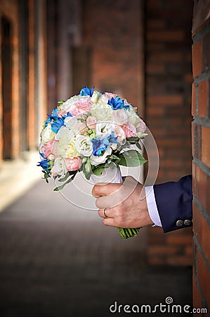 Bouquet of flowers in the hand of the groom Stock Photo