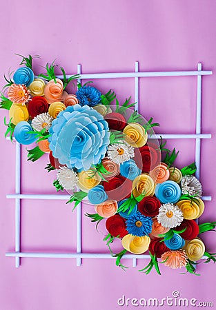 bouquet of flowers made with paper on a pink surface Stock Photo