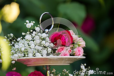 Bouquet of flowers on whatnot for cake. Decoration of celebration with fresh flowers. Floral decor for weddings and banquets Stock Photo