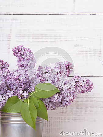 Bouquet of lilac flowers on white wooden background Stock Photo